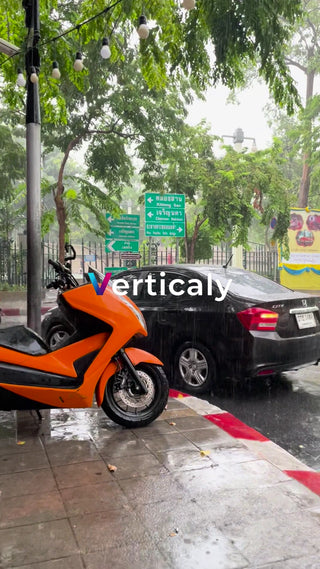雨の日の街並み、バイクと黒い車