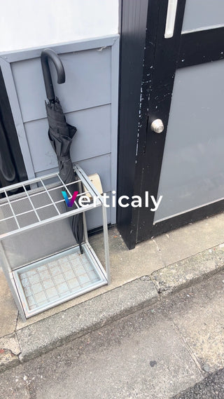 Black umbrella in an umbrella stand