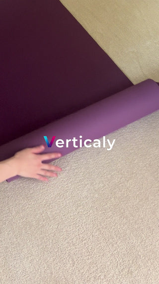 Hands unfolding a yoga mat