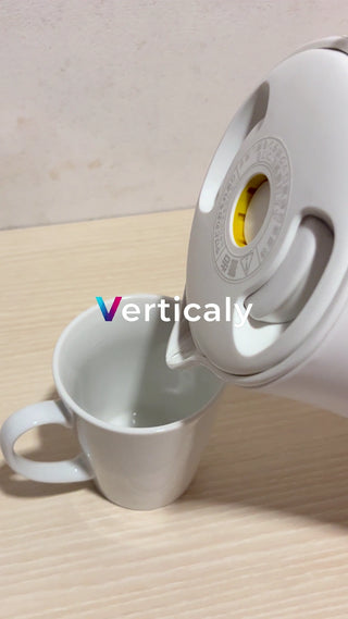 Steaming hot water into a white porcelain cup