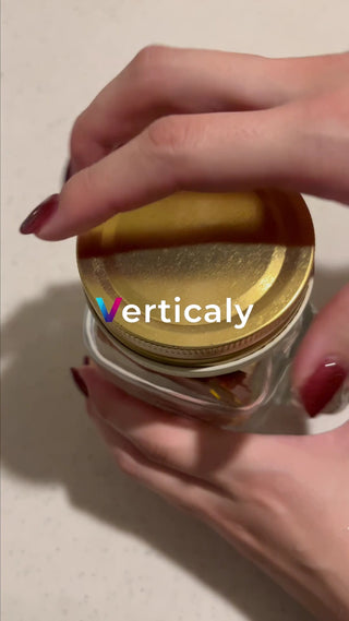 A woman's hand opens the lid of a bottle