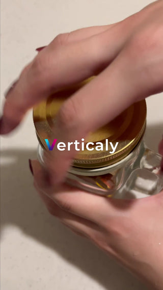 Hand opening the lid of the bottle